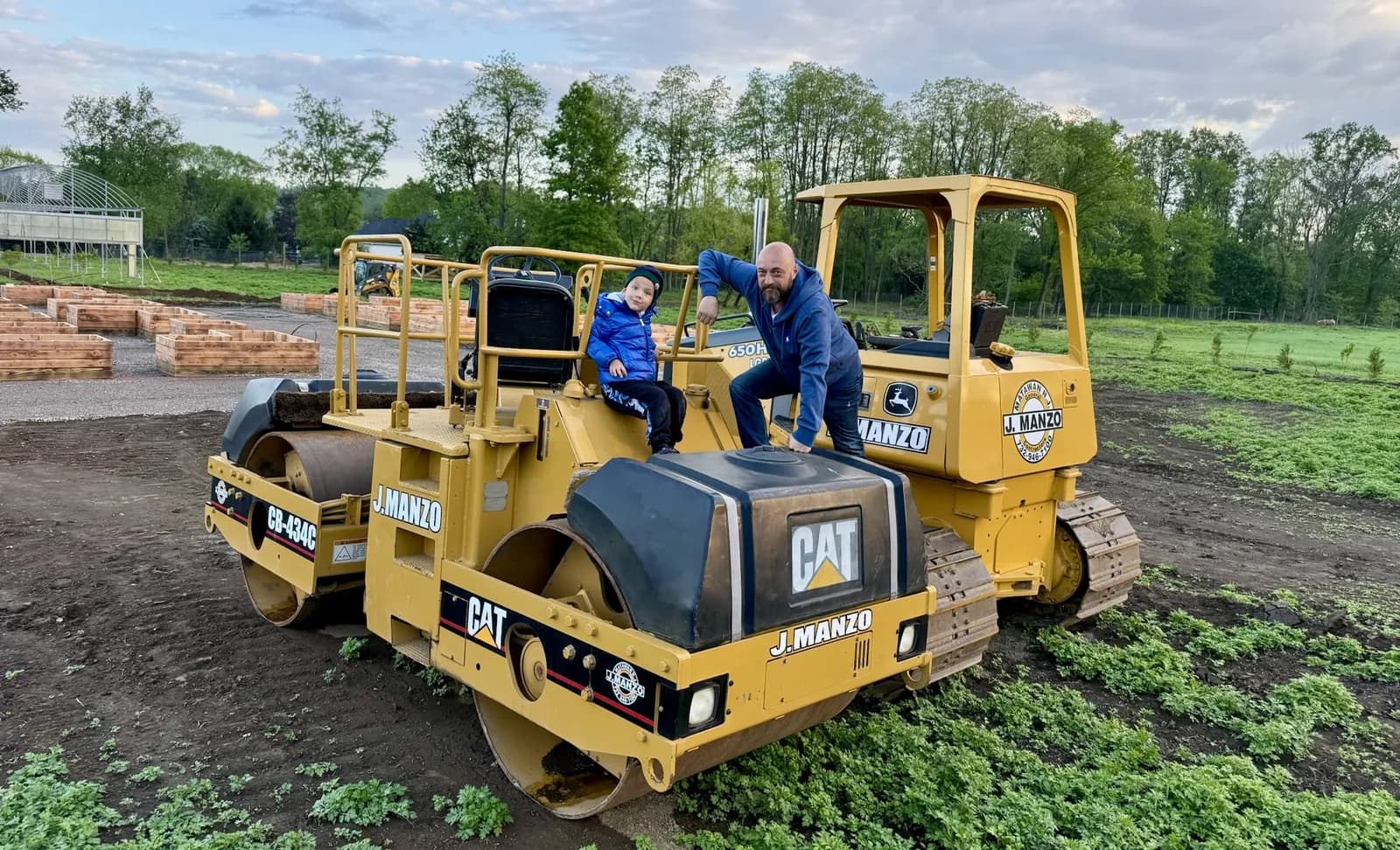 Kids riding on the farm's yellow loader in the field